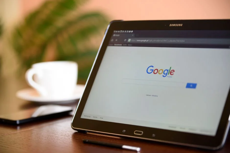 A team in an office is reviewing financial charts and digital data on tablets.